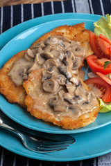 Crispy fried homemade potato pancakes with mushroom sauce.