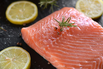 Raw salmon fillets served with lemon