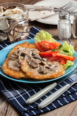 Crispy fried homemade potato pancakes with mushroom sauce.
