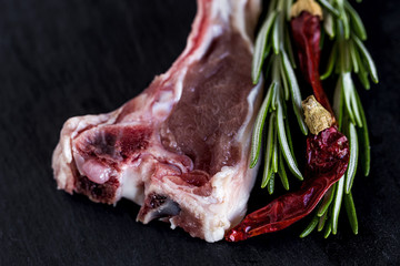 Raw lamb ribs on black background