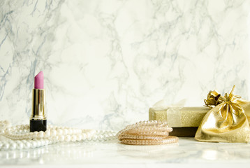 jewelry and cosmetics on marble table