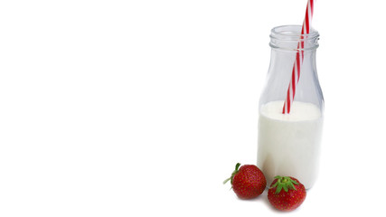 bottle with milk and strawberries on a white background