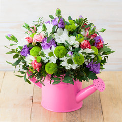 bouquet of flowers in watering can