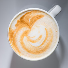 close-up cup of coffee with little art, flat lay