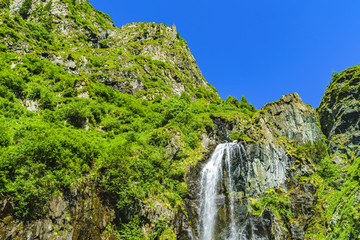 Fototapeta na wymiar Beautiful waterfall in the mountains of Fagaras Romania