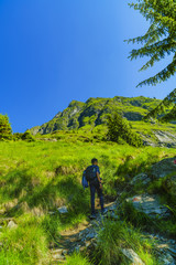 Young boy explores nature on the mountain