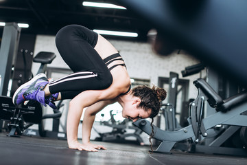 Fototapeta na wymiar Flexible young woman train in the gym