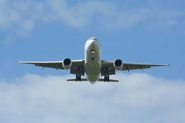 Passenger Airplane Landing with cloud and blue sky