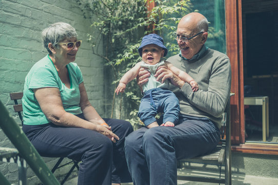 Grandparents in yard with baby