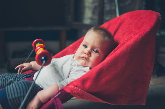 Little Baby Sitting In A Bouncy Chair