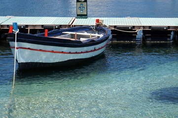Obraz premium Blue sea and moored boat