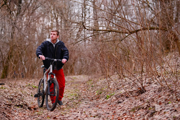 cyclist riding a mountain bike along the forest road