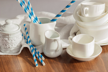 Set of white empty tableware with striped tubules