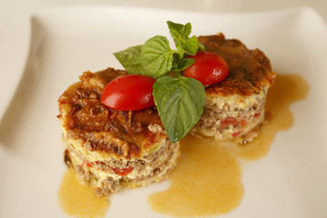 Moussaka arranged on a plate, Traditional dish in elegant setting, Selective focus with soft light