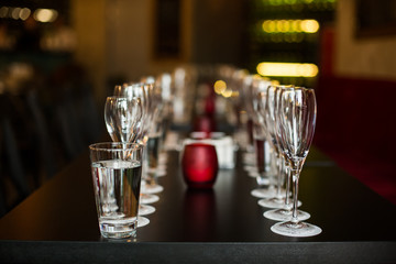 Wine glasses stand on the table, dishes.