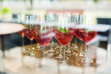 View of red refreshing cocktails in wine glasses with ice.