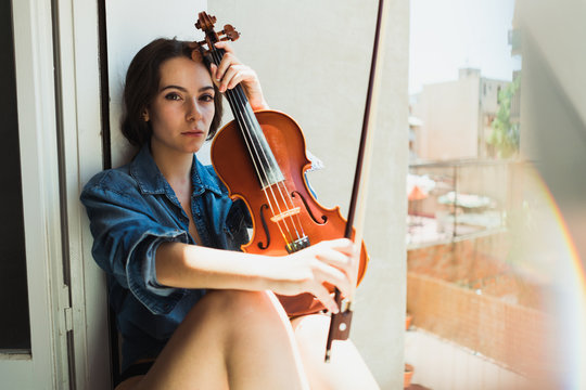 Wonderful model with violin in sunlight