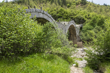 Fototapeta na wymiar Kalogeriko triple arched stone bridge