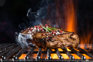Beef steaks on the grill with flames