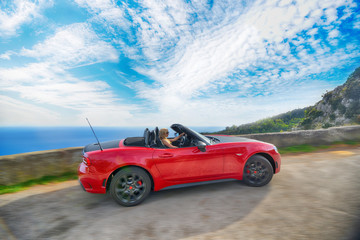 Woman and red cabriolet