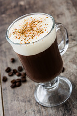 Irish coffee in glass on wooden table
