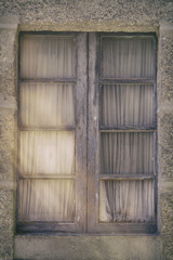 Close-up of window in wooden frame with curtains