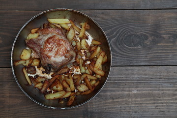 dinner with pan fried meat and potatoes on a table