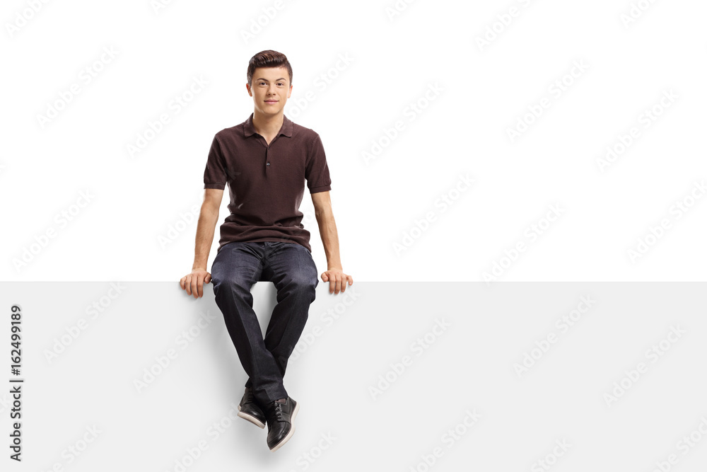 Sticker Teenage boy sitting on a panel