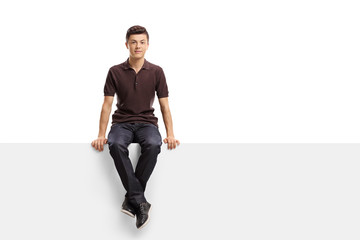 Teenage boy sitting on a panel - Powered by Adobe