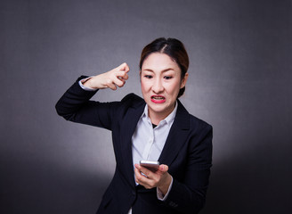 Attractive Modern asian business woman model with Black hair in Suit Playing Smart Phone different emotion such as  Angry,edgy,shock,be smile,love,wow,glad,cheer,Press the button, internet of things