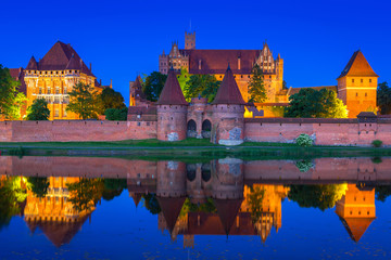 Naklejka na ściany i meble The Castle of the Teutonic Order in Malbork at night, Poland