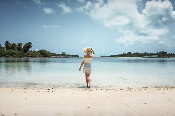 Fototapeta na wymiar Girl in white dress on the beach. Maldives. Tropics. Vacation.