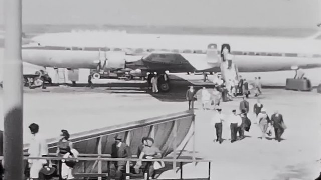 Switzerland, 1960s : People descend and climb from the Swiss airplane