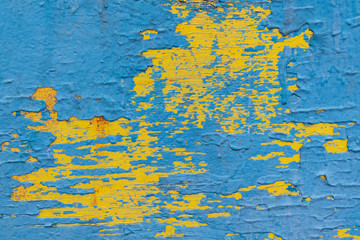 Wooden surface painted with paint in several layers.