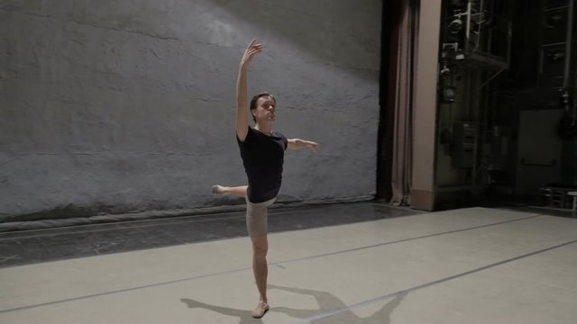 Dancing man modern ballet dancer performs dance in studio 60 fps slow motion