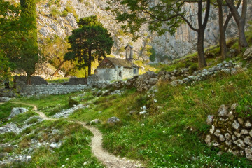 Fototapeta na wymiar Hidden church ruins in lush mountainous valley, outside of Kotor, Montenegro