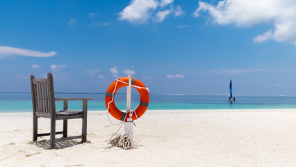 Lifebuoy on the tropical beach - 162510196