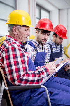 Colleagues wearing hard hats checking document