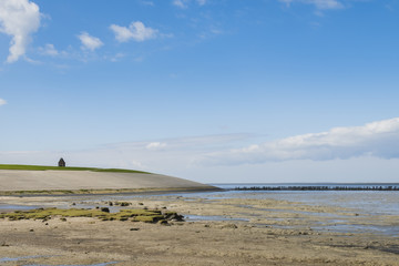 Mud-flats and Dike of Waddensea and Church