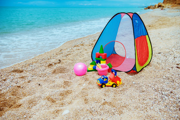 Children's tent and children's toys on the beach