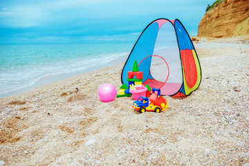 Children's tent and children's toys on the beach