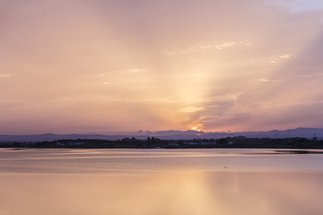 Fototapeta na wymiar Pink orange and purple Carnon-Plage Montpellier sunset above water southern France