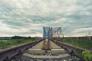 View of the old train bridge over a river.