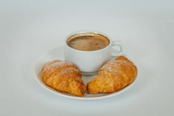 Lush croissants with fragrant coffee for breakfast