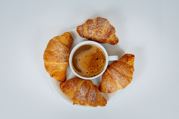 Lush croissants with fragrant coffee for breakfast