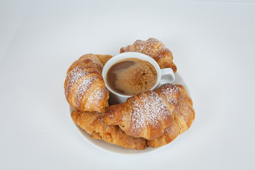 Lush croissants with fragrant coffee for breakfast