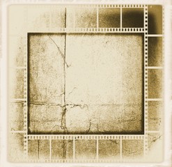Vintage sepia film strip frame on old and damaged paper background.