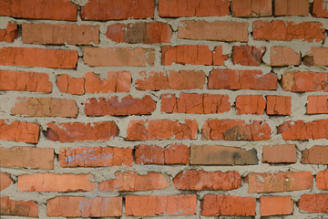 Inaccurate brickwork. Brick wall made of red ceramic brick.