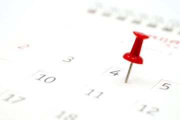 Embroidered red pins on a calendar on the 4th July with selective focus, independence day