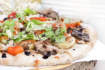 Fresh italian pizza with mushrooms, ham, tomatoes, cheese on light white background.